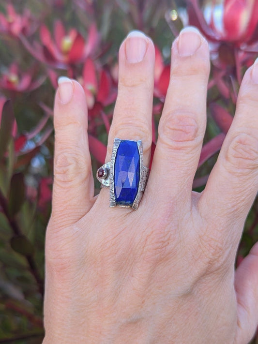 Woman wearing the Lapis Epoch Ring by K. Elizabeth Jewelry, highlighting its organic bark-textured silver band and natural gemstone details.