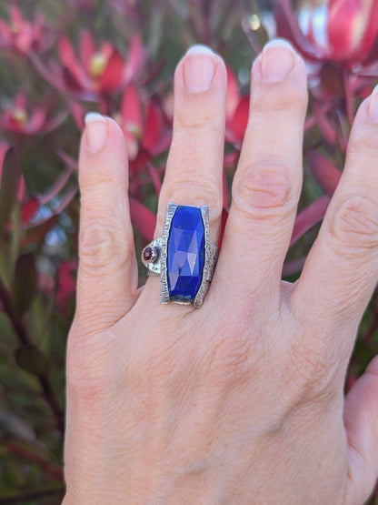 Woman wearing the Lapis Epoch Ring by K. Elizabeth Jewelry, highlighting its organic bark-textured silver band and natural gemstone details.